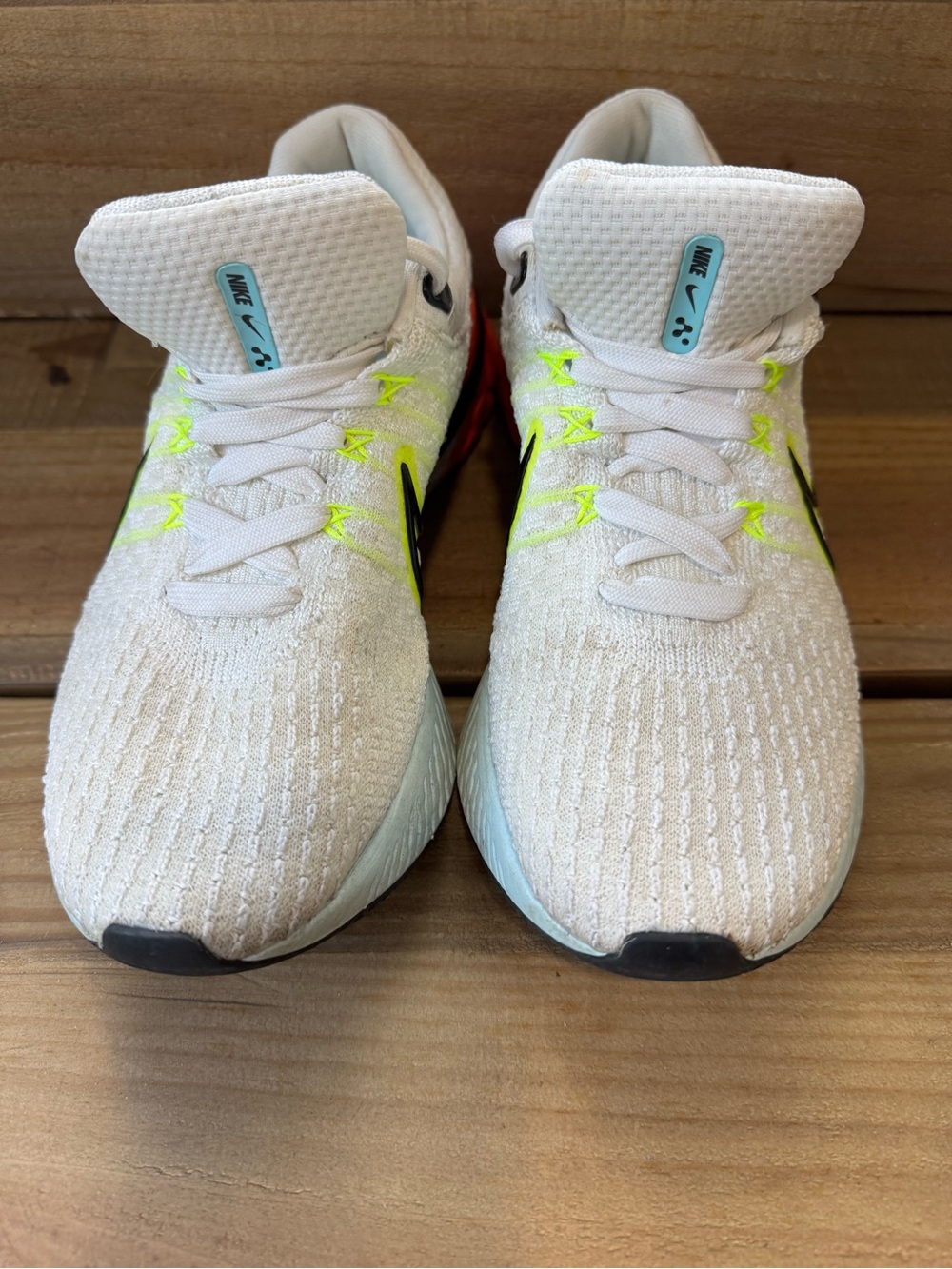 Nike White Flyknit Sneakers with Neon Yellow and Black Accents